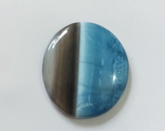 May include: A round, blue and brown gemstone cabochon with a white stripe.