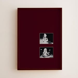 May include: A framed artwork featuring two black and white photographs. The photographs depict a person in a turban, using a telephone. The frame is a deep burgundy color, and the background is a neutral off-white.