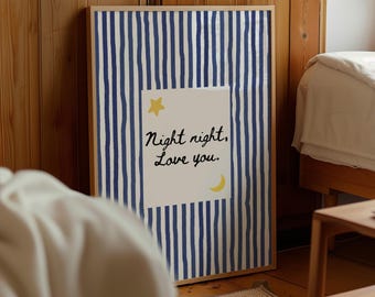 May include: A framed print with a blue and white striped background. A white rectangle in the center features the text "Night night, Love you." A yellow star and crescent moon are also present. The frame is a light wood color.