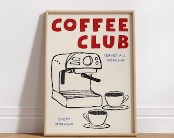 May include: A framed art print with a cream background and a coffee theme. The words "COFFEE CLUB" are in red, with "SERVED ALL MORNING" and "EVERY MORNING" in blue. A black and white illustration of an espresso machine and two coffee cups.