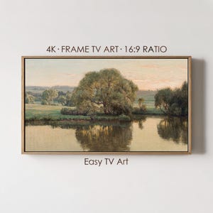 May include: A framed landscape painting featuring a serene river scene with trees and a soft, golden sky. The artwork is labeled "4K Frame TV Art 16:9 Ratio" and "Easy TV Art."
