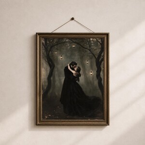May include: A framed wall art print depicting two figures in long black clothing embracing in a dark, misty forest. The scene features twisted tree branches and several small, glowing lanterns suspended in the air, all enclosed in a dark frame.