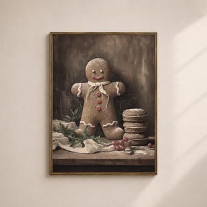 May include: A framed print featuring a gingerbread man with white icing details, a red bow tie, and red buttons. A stack of cookies and red berries are also on the wooden surface. The background is a dark, textured wall.