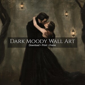 May include: A digital wall art print featuring a couple in dark clothing embracing in a forest with hanging lanterns. The image includes the text DARK MOODY WALL ART and Download > Print > Frame in white lettering over a dark rectangular overlay.