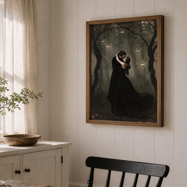 May include: A framed wall art print depicting two figures in dark clothing embracing in a misty, dark forest setting. The scene is illuminated by several small, glowing lanterns hanging from the twisted, dark tree branches above the couple.
