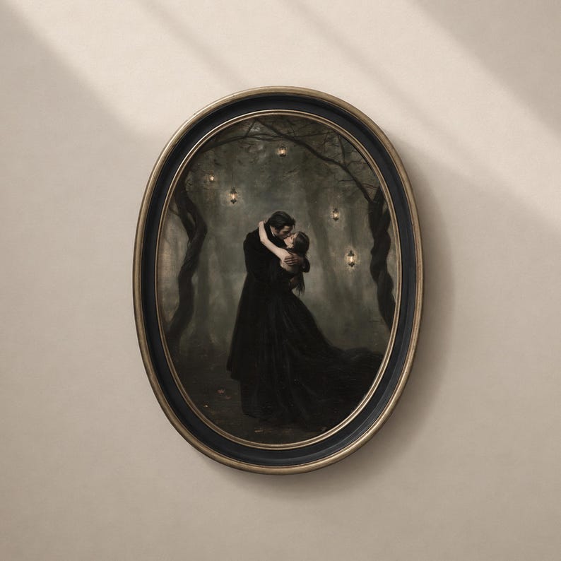 May include: An oval-framed wall art piece featuring a dark, moody painting of two figures in black clothing embracing in a misty forest. The scene is illuminated by small, glowing lanterns hanging from the twisted, dark tree branches above them.