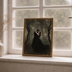 May include: A rectangular framed wall art print featuring a dark, atmospheric forest scene with two figures in black clothing embracing. The forest is illuminated by small, glowing lanterns hanging from the trees, creating a moody, dim aesthetic.