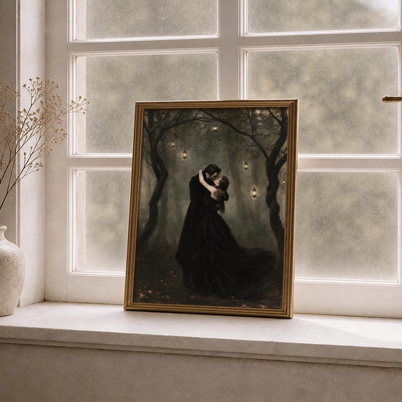 May include: A rectangular framed wall art print featuring a dark, atmospheric forest scene with two figures in black clothing embracing. The forest is illuminated by small, glowing lanterns hanging from the trees, creating a moody, dim aesthetic.