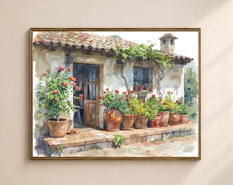 May include: Watercolor painting of a rustic cottage with a terracotta tile roof and a wooden door. Potted plants with red flowers line the porch. The artwork is framed in a brown wooden frame.
