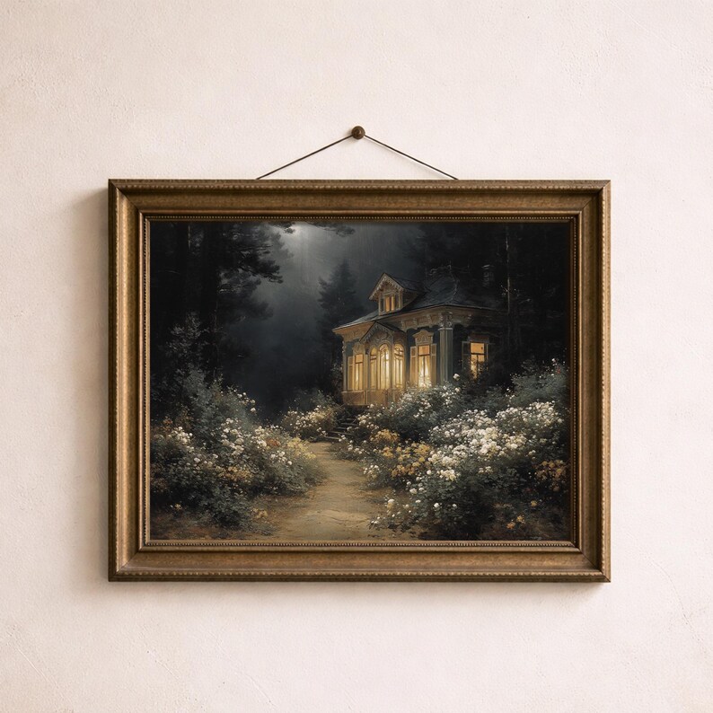 May include: A framed painting depicts a house illuminated by warm light, nestled in a dark forest. The artwork features a path leading to the house, surrounded by white and yellow flowers. The frame is a warm gold color.