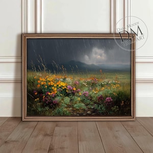 以下が含まれることがあります： 嵐の空の下、野の花が咲き乱れる風景を描いた額装された絵画。空は暗い灰色で雨が降っており、遠くの山々は雲に覆われています。花は黄色、ピンク、紫が混ざり合っています。