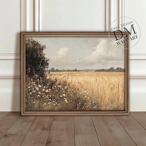 Puede incluir: Una pintura enmarcada de un campo de trigo con un árbol verde oscuro en primer plano. El cielo es de un azul claro con nubes blancas. La pintura está en un marco marrón.