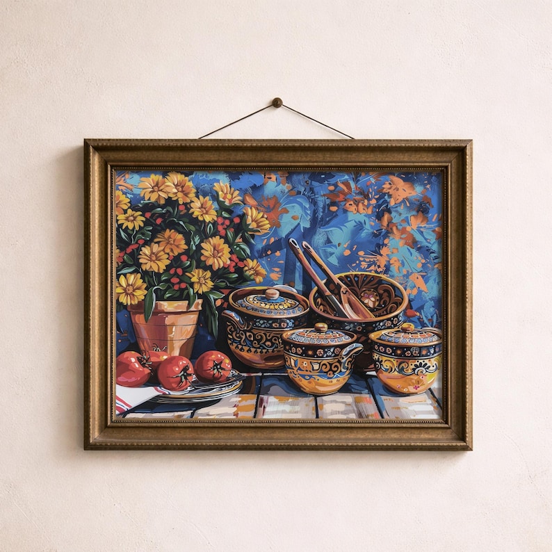 May include: A framed still life painting featuring a terracotta pot of yellow flowers, red tomatoes, and decorative ceramic bowls with lids. The bowls have intricate patterns in blue, yellow, and brown. Wooden spoons rest in a bowl.