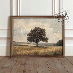 May include: A framed landscape painting of a lone tree in a field. The tree is a dark green color and the field is a light brown color. The sky is a light blue color with some clouds. The painting is in a wooden frame.