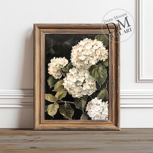 May include: A framed painting of white hydrangeas with green leaves against a dark background. The painting is in a rustic wooden frame.