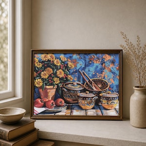May include: A framed still life painting featuring a terracotta pot of yellow flowers, red tomatoes, and decorative ceramic bowls with lids. The painting has a blue and orange background and is displayed on a windowsill.