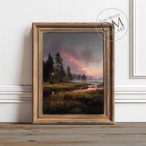 May include: A framed landscape painting depicts a serene forest scene at dusk. The artwork features a river, trees, and a vibrant sky with shades of pink and orange. The frame is a warm, golden brown.