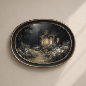 May include: Oval framed artwork depicting a house at night. The house is illuminated by warm light, surrounded by a path and white flowers. The frame is black with a gold inner edge, mounted on a neutral wall.