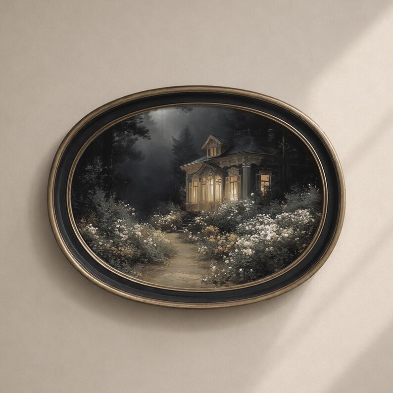 May include: Oval framed artwork depicting a house at night. The house is illuminated by warm light, surrounded by a path and white flowers. The frame is black with a gold inner edge, mounted on a neutral wall.