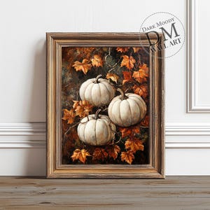 May include: A framed painting of three white pumpkins with brown stems, surrounded by orange and brown autumn leaves. The painting has a rustic, vintage feel.