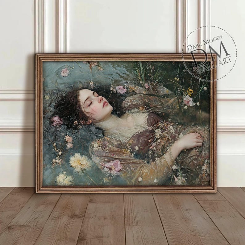 May include: A framed artwork depicts a woman floating in water, surrounded by flowers. The painting features a muted color palette with shades of brown, pink, and blue. The artwork is labeled "Dark Moody Wall Art" in a circular logo.