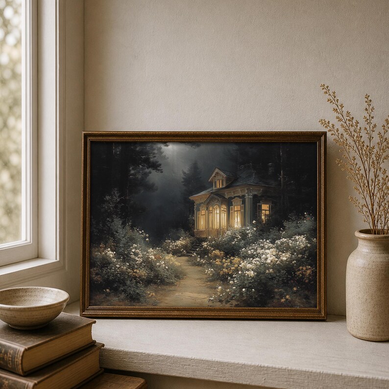 May include: A framed art print depicts a cottage illuminated by warm light, nestled in a dark forest. A path leads to the cottage, surrounded by white flowers. The artwork is in a brown wooden frame.