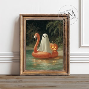 May include: A framed print depicting a Halloween scene. A white ghost sits on an orange flamingo pool float with a carved pumpkin. The background shows a tropical beach with palm trees. The frame is a warm brown colour. The text "DARK MOODY WALL ART" is in the upper right corner.