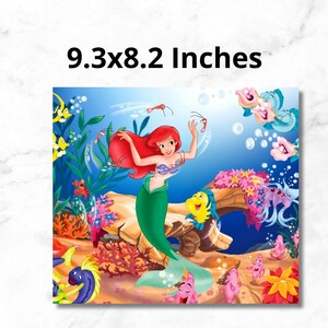 May include: A colorful illustration of Ariel, the Little Mermaid, swimming in the ocean with other sea creatures. The image is 9.3x8.2 inches.