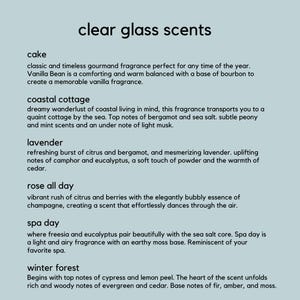 May include: A light blue background displays the text "clear glass scents." The image lists scent descriptions such as "cake," "coastal cottage," "lavender," "rose all day," "spa day," and "winter forest."