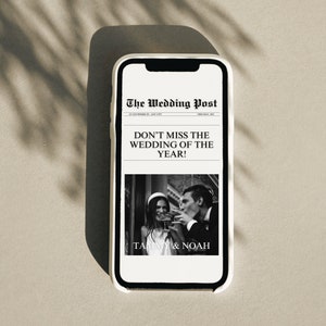 May include: A black and white image of a wedding announcement on a smartphone screen. The headline reads "Don't Miss The Wedding Of The Year!" with the couple's names "Tammy & Noah" below a photo of them.