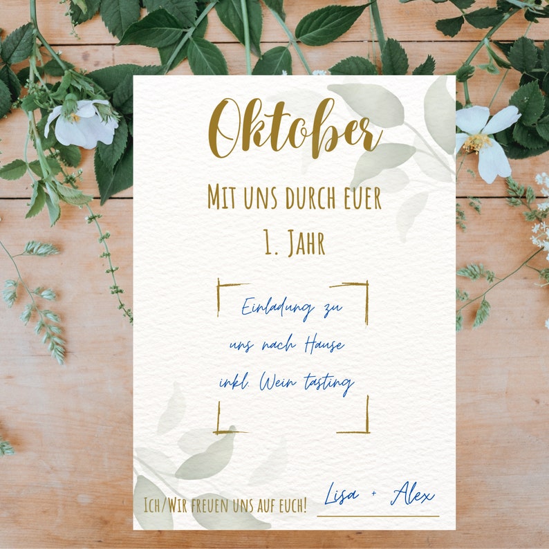 May include: A cream-coloured invitation card with gold and blue text, featuring the word "Oktober" at the top. The card includes text about a first-year celebration and a wine tasting. Floral elements and greenery surround the card.
