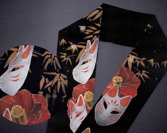 May include: Black fabric with a repeating pattern of white fox masks, red flowers, and gold bamboo stalks.