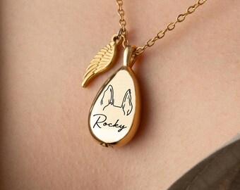 May include: Gold-colored teardrop pendant necklace with a chain and a small feather charm. The pendant features a black line drawing of a dog's face and the name "Rocky" in script.