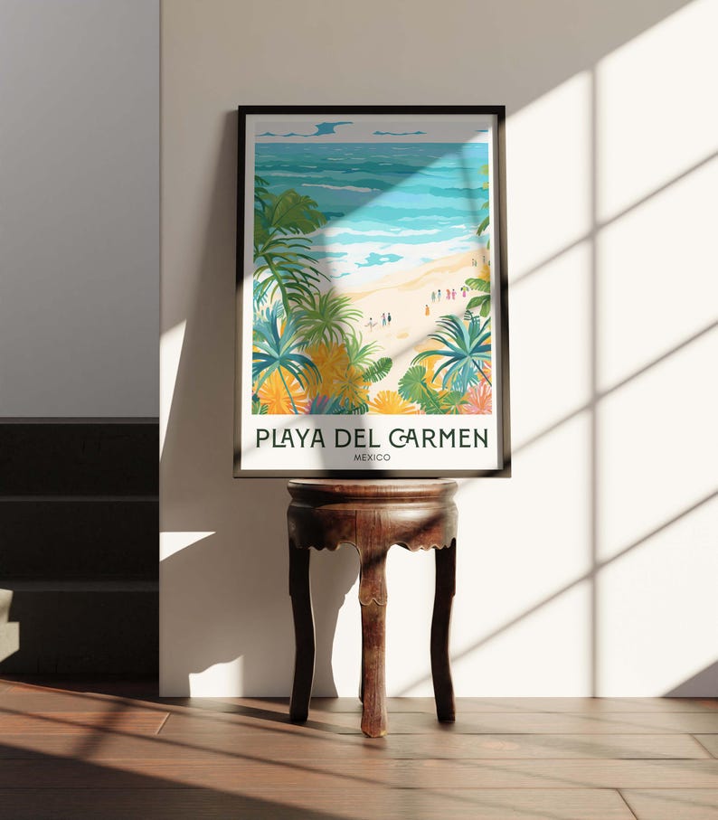 May include: A framed poster featuring a colourful illustration of a beach scene in Playa del Carmen, Mexico. The poster depicts a view of the ocean, beach, and palm trees. The text "PLAYA DEL CARMEN" and "MEXICO" is printed below the illustration.