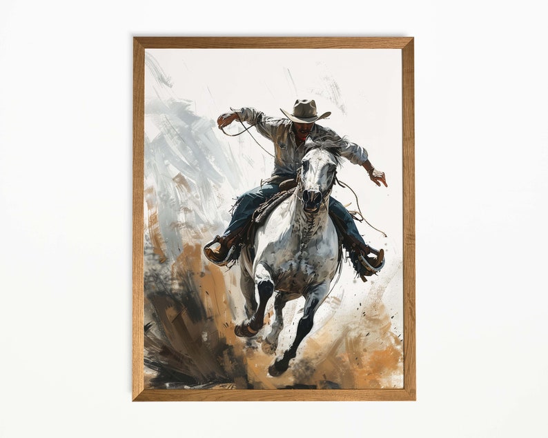 Op de afbeelding: Een ingelijste kunstdruk toont een cowboy op een wit paard, lasso&euml;nd. De cowboy draagt een hoed en spijkerbroek. Het kunstwerk gebruikt wit, bruin en blauw, met dynamische penseelstreken die beweging suggereren.
