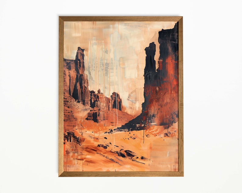 Op de afbeelding: Abstracte kunstprint van een woestijnlandschap, met tinten oranje, bruin en zwart. Het kunstwerk is ingelijst in een natuurlijke houten lijst. De schildering toont torenhoge rotsformaties en een uitgestrekt, open landschap.