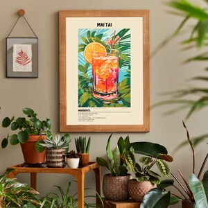 May include: A framed print of a Mai Tai cocktail with a slice of orange and a cherry. The print has a tropical theme with green leaves and flowers. The text "MAI TAI" and "INGREDIENTS" are visible on the print.
