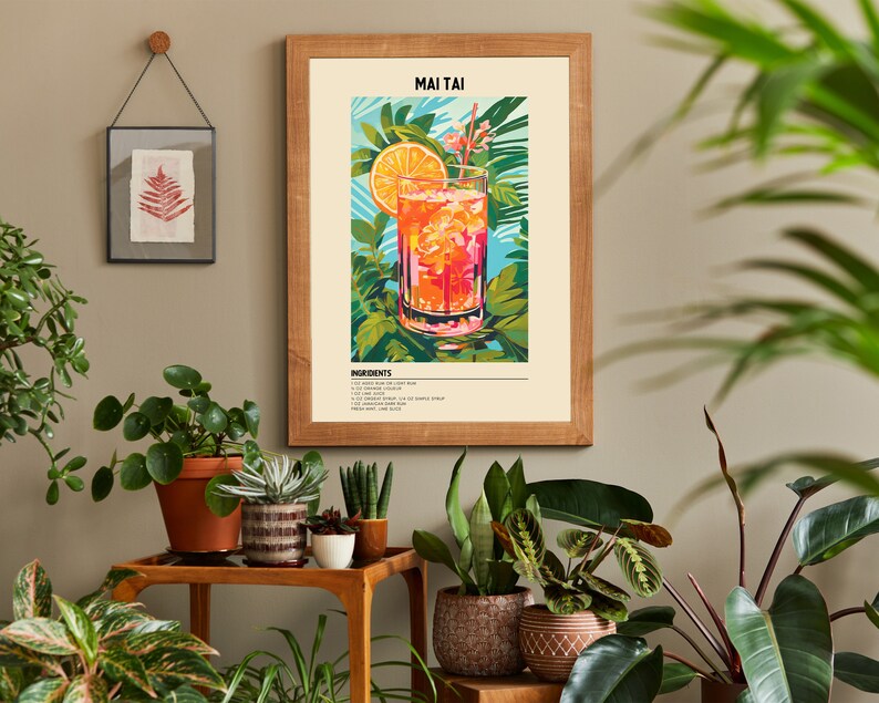 May include: A framed print of a Mai Tai cocktail with a slice of orange and a cherry. The print has a tropical theme with green leaves and flowers. The text "MAI TAI" and "INGREDIENTS" are visible on the print.
