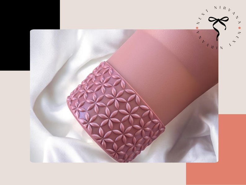 a pink vase sitting on top of a white sheet
