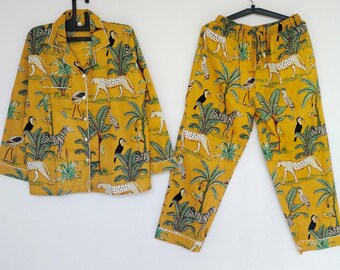 May include: Yellow pyjama set with a jungle print featuring zebras, leopards, toucans, and palm trees.