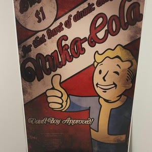 May include: A vintage-style poster advertising Nuka-Cola, a fictional beverage from the Fallout video game series. The poster features a cartoon character, Vault Boy, giving a thumbs up and the text "Only $1 for that burst of atomic energy Nuka-Cola Vault-Boy Approved!"