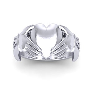 May include: A silver ring with two hands clasping a heart in the center. The ring is a Celtic design.