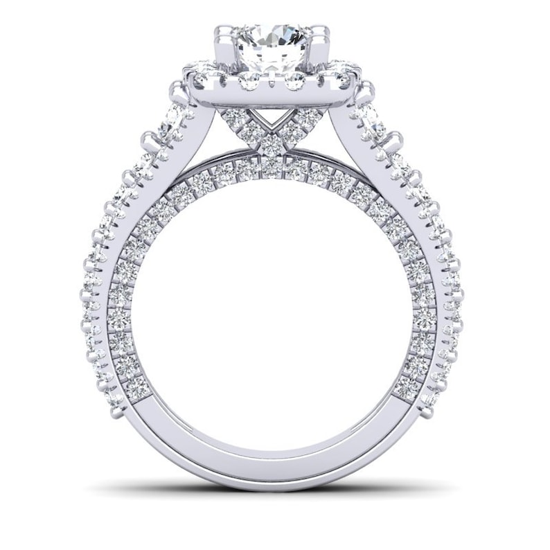May include: A silver engagement ring with a large center diamond surrounded by smaller diamonds. The ring has a double band with diamonds set in a pave setting.