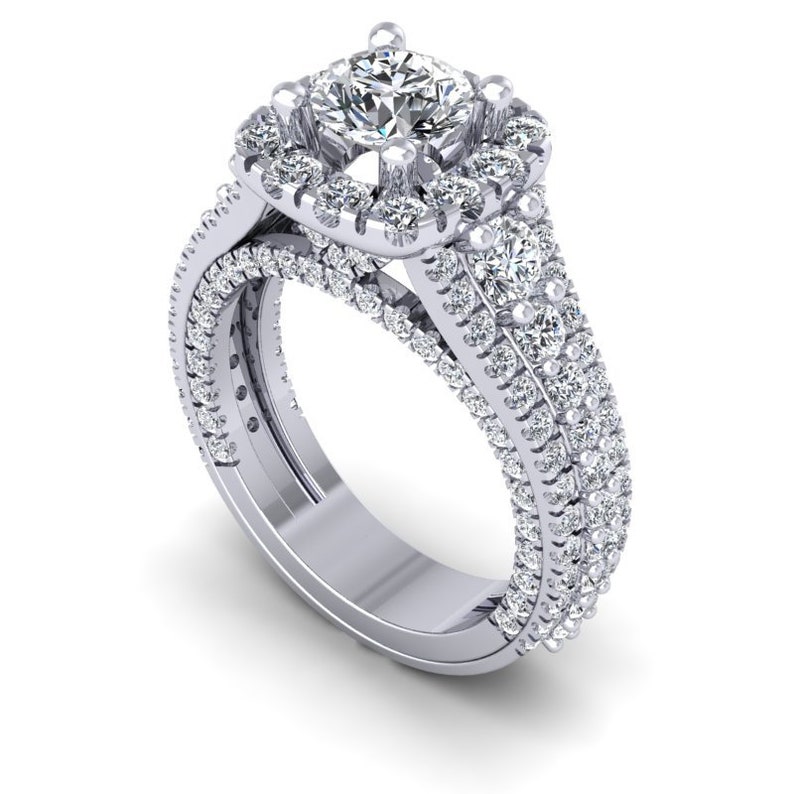 May include: A silver engagement ring with a large, square-cut diamond surrounded by a halo of smaller diamonds. The band is adorned with a double row of smaller diamonds.