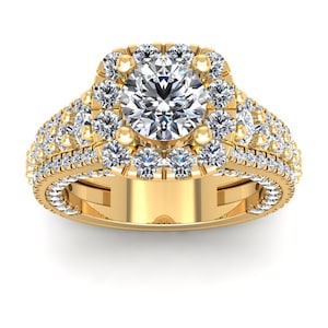 May include: A gold engagement ring with a large, round, center diamond surrounded by a halo of smaller diamonds. The band is also set with smaller diamonds.
