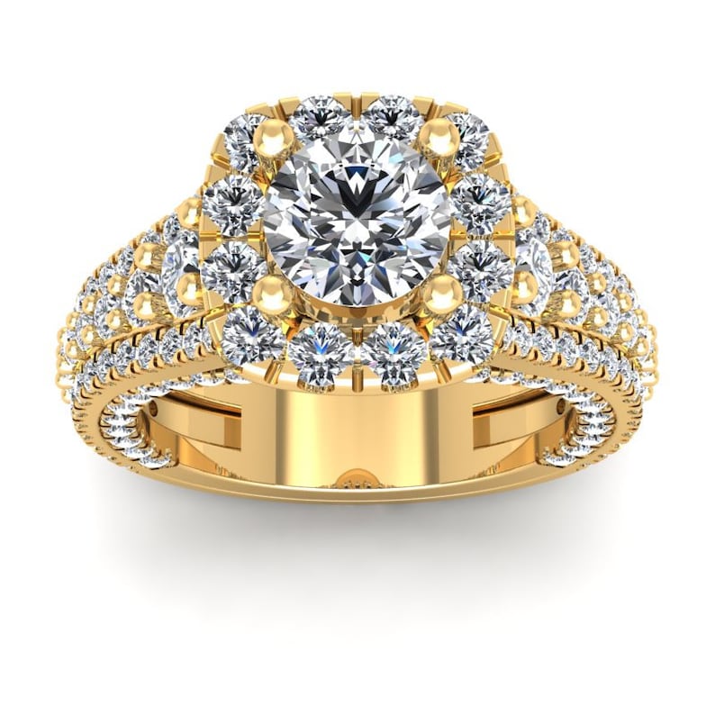 May include: A gold engagement ring with a large, round, center diamond surrounded by a halo of smaller diamonds. The band is also set with smaller diamonds.
