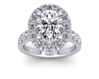 May include: A silver engagement ring with an oval-shaped center diamond surrounded by a halo of smaller diamonds. The band is also set with smaller diamonds.