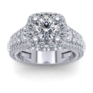 May include: A silver engagement ring with a large round center diamond surrounded by a halo of smaller diamonds. The band is also set with smaller diamonds.