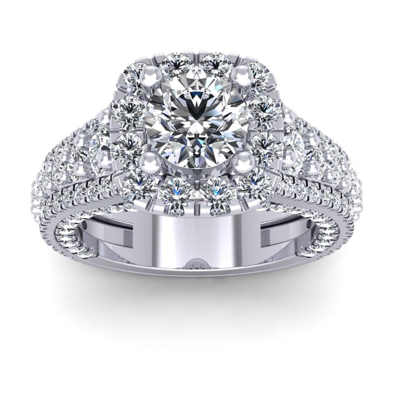 May include: A silver engagement ring with a large round center diamond surrounded by a halo of smaller diamonds. The band is also set with smaller diamonds.