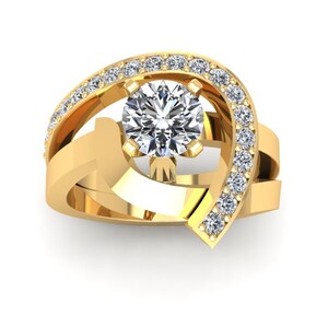 May include: A gold ring with a large round diamond in the center and smaller diamonds set in a curved band around the center stone.